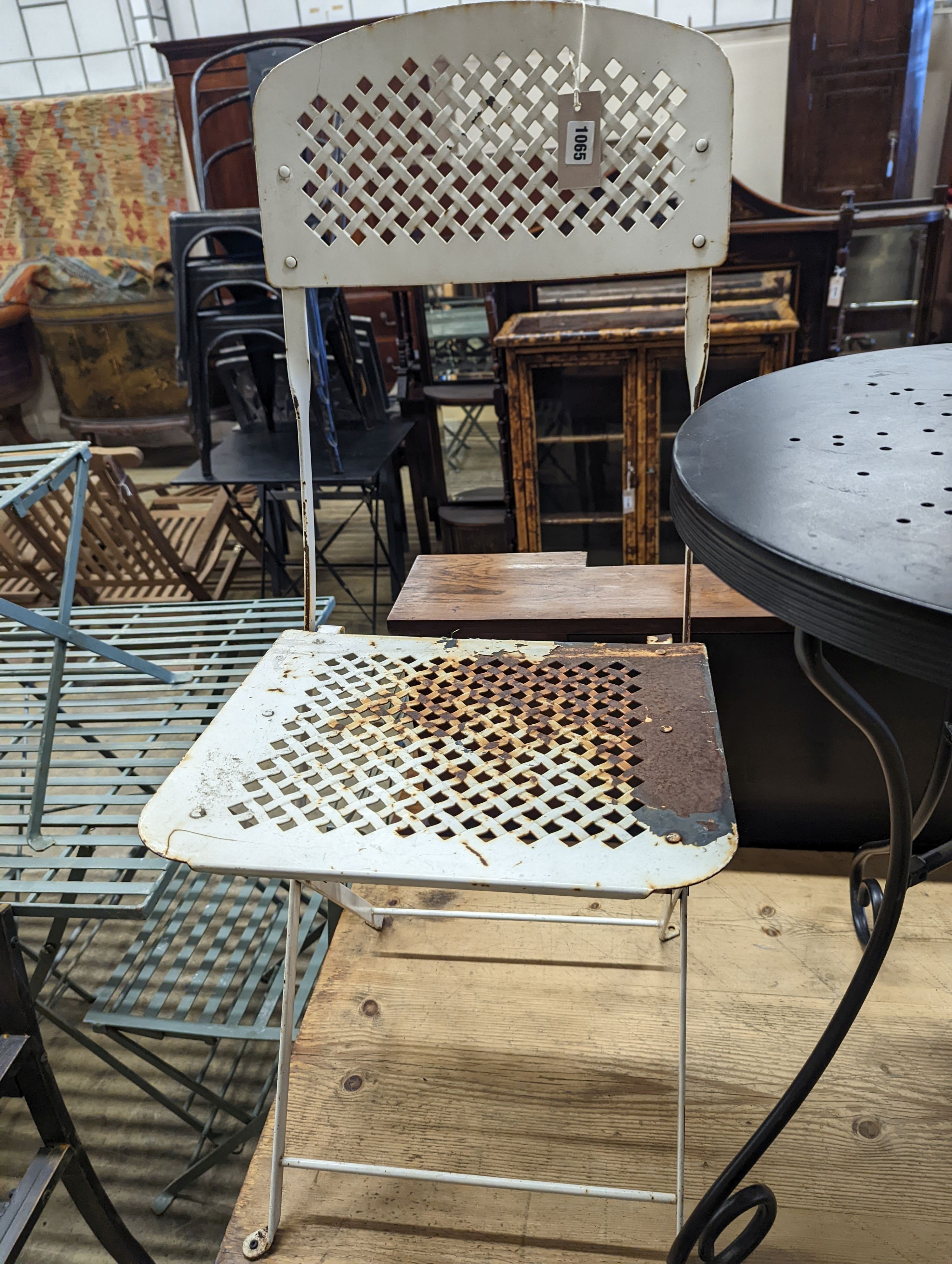 A circular metal bistro table, diameter 49cm, height 65cm and two chairs